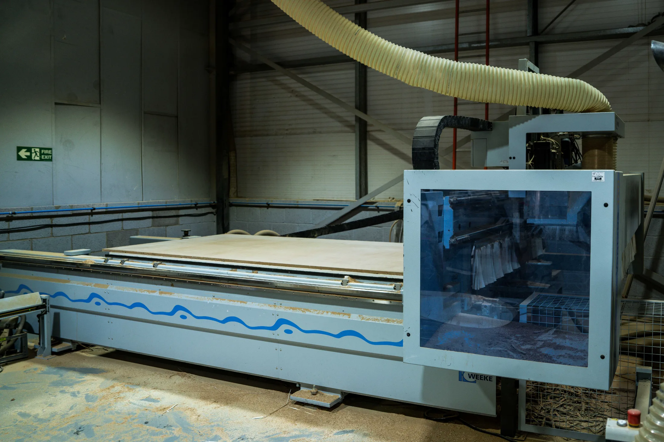 HOMAG wood CNC router with a full sheet loaded on the bed in the CNC Production workshop