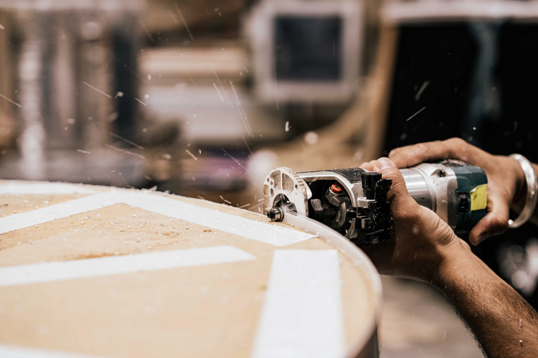 CNC router spindle profiling a curved panel with live dust extraction