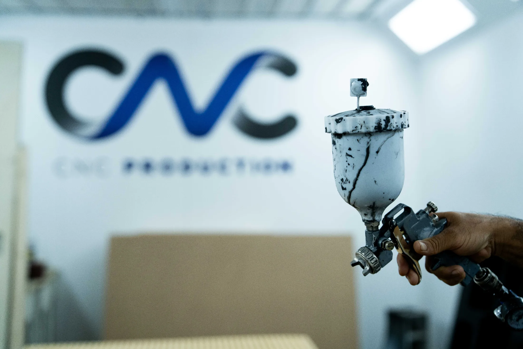 HVLP spray gun used for colour-matched paint finishing at CNC Production