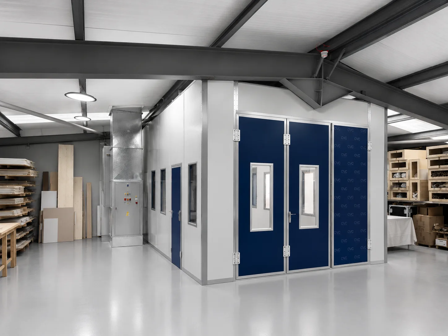 CNC Production spray booth with blue doors inside the workshop