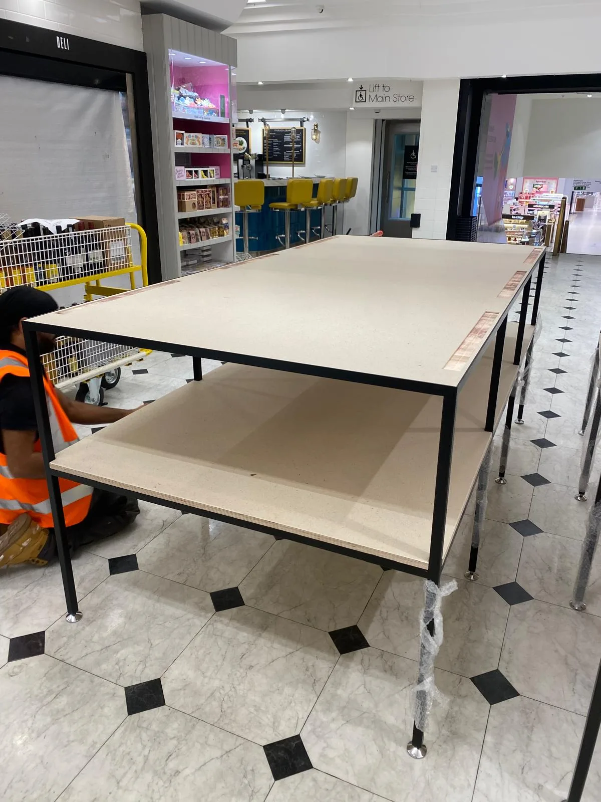 Steel display table during on site installation by the CNC Production team